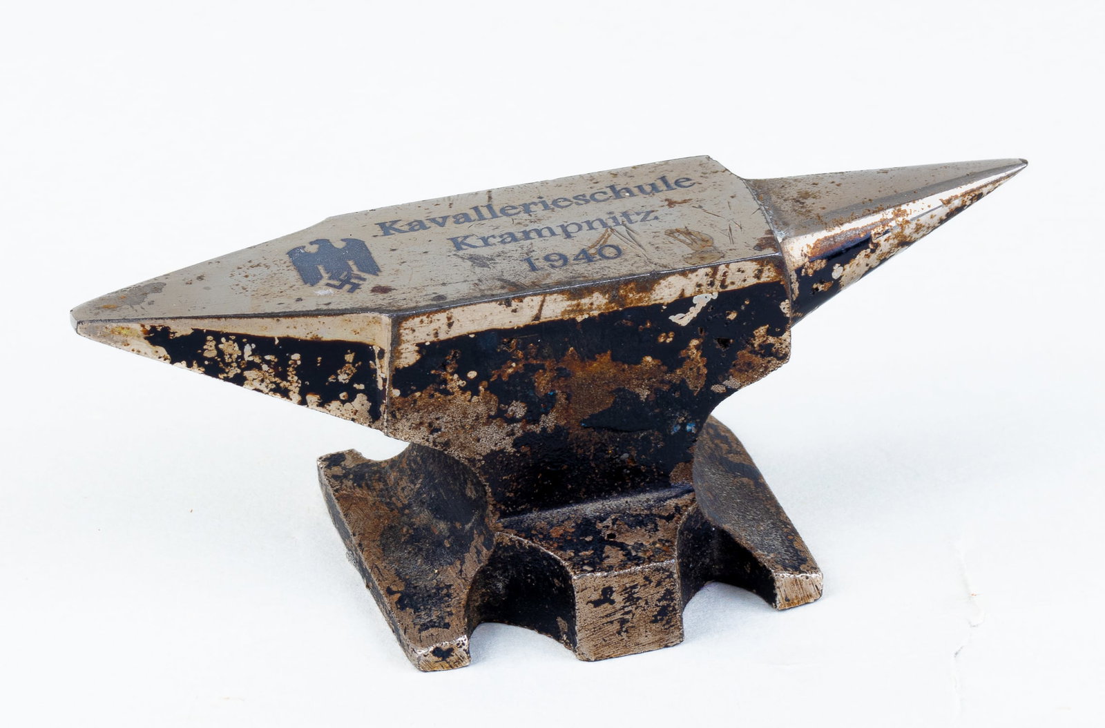 KAVALLERIESCHULE KRAMPNITZ ANVIL: A small anvil with 'Kavallerieschule Krampnitz 1940' (Krampnitz Cavalry School 1940) inscribed on the top of the anvil with an eagle holding a swastika next to the inscription.
