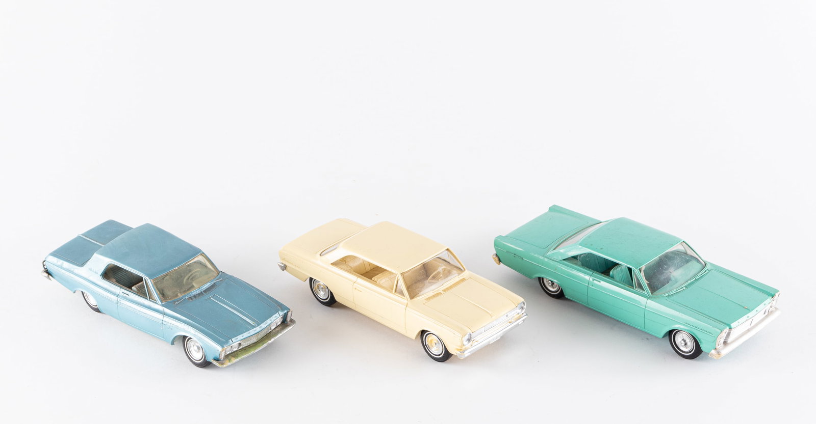 3 1960'S PROMOTIONAL SALESMAN SAMPLES CARS: Three 1960s promotional cars, includes a Rambler American 440 in yellow, 7.75 inches long, a Plymouth Fury in blue,8 inches long, and a Ford Galaxy in teal, 8.5 inches long. Fury has clouded windows a