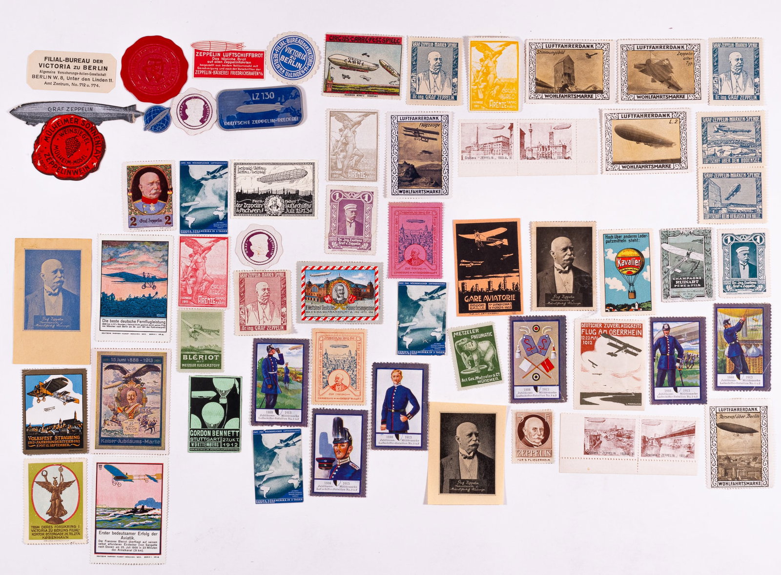 61 ZEPPELIN STAMPS: Lot of 61 pre-war Zeppelin cinderella stamps and stickers, featuring illustrations of Zeppelin airships, portraits of Ferdinand von Zeppelin, portraits of Kaiser Wilhelm II, hot air balloons, early pl