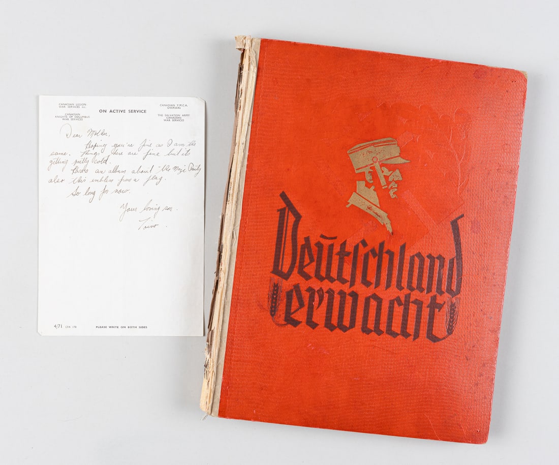CAPTURED NAZI BOOK DEUTSCHLAND ERWACHT: Captured copy of the WWII German Nazi propaganda book 'Deutschland Erwacht' [German awakens], a cigarette album in support of Adolf Hitler and his Nazi party. The album was captured by Canadian soldie