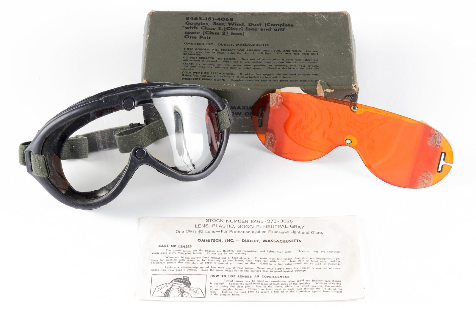 US WWII ARMY GOGGLES: A pair of U.S. WWII sun, wind, and dust goggles in the original packaging. The goggles include extra lenses and a manual. On the box are directions for wear and cleaning. The box is numbered '8465-161