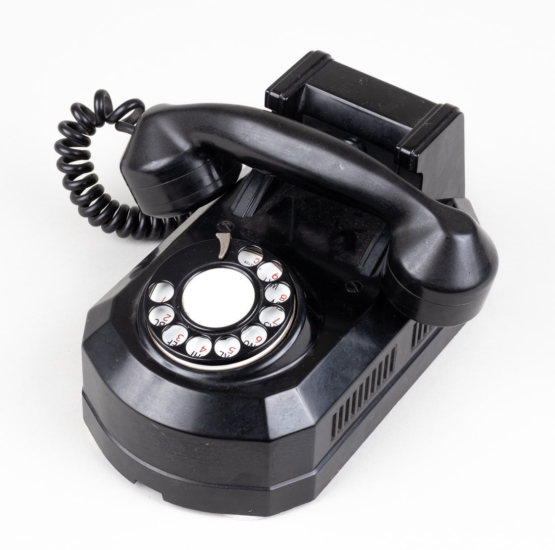 AUTOMATIC ELECTRIC CO. WALL MOUNT TELEPHONE: Automatic Electric Co. model AE 50 Coffin/Tombstone style wall mount telephone, circa 1940s-1950s, black Bakelite telephone with black Bakelite receiver and rotary dial. On verso marked 'S L 501600 XL