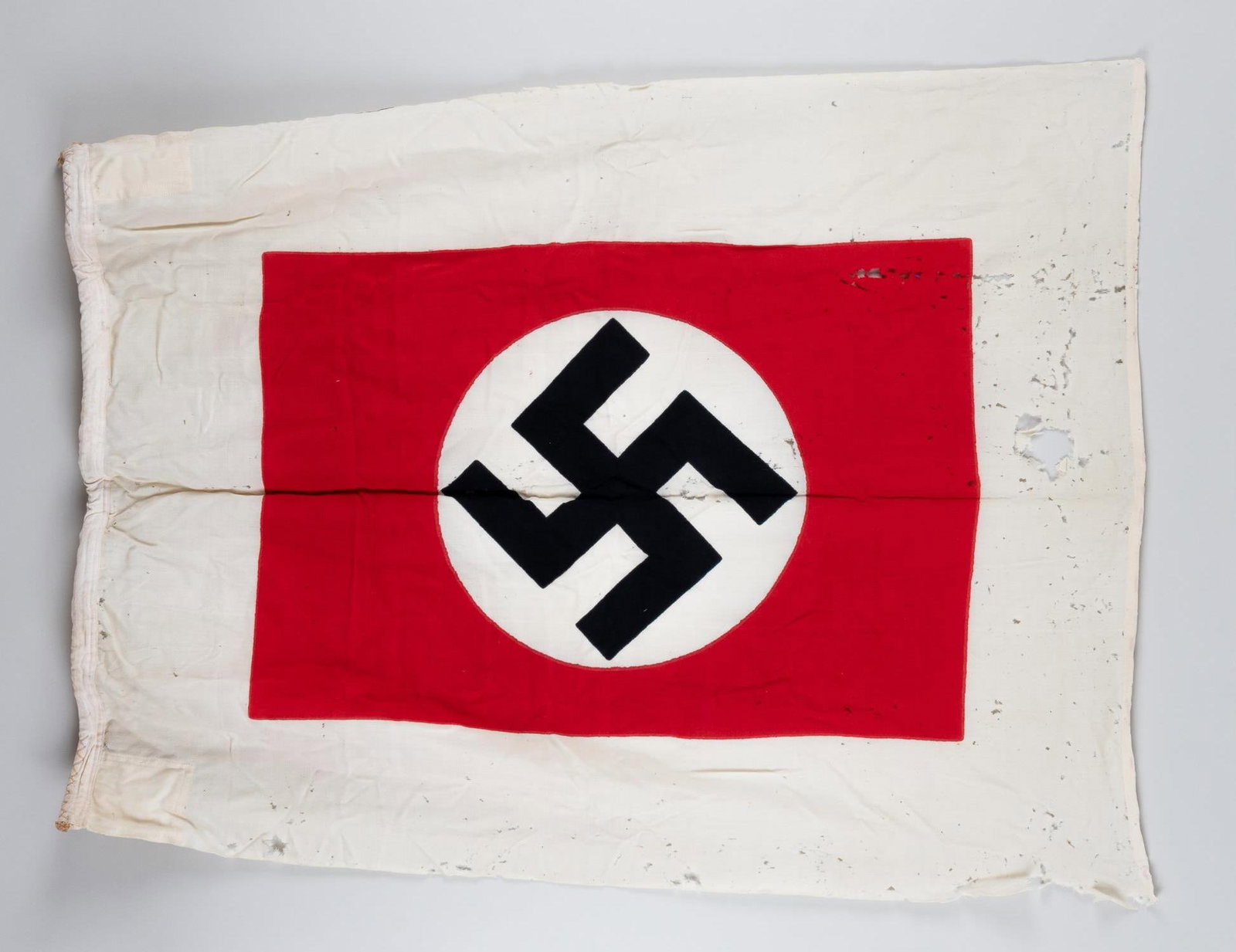 WWII GERMAN KRIEGSMARINE HARBOR PILOT'S SIGNAL FLAG: Original WWII German Kriegsmarine naval harbor pilot or signal flag (Lotsenflagge). Swastika flag in a white bordered field. In use from 1935 until 1945. The flag is marked and stamped on the hoist 'F