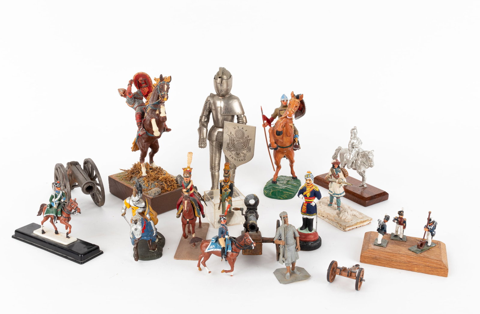 14 HAND-PAINTED SOLDIER FIGURINES: Fourteen hand-painted soldier figurines, includes a 1st century B.C. Roman legion cavalry soldier and Elastolin medieval knight on horseback. WITH: a miniature canon and Gatling gun. Approx. 6 inches 