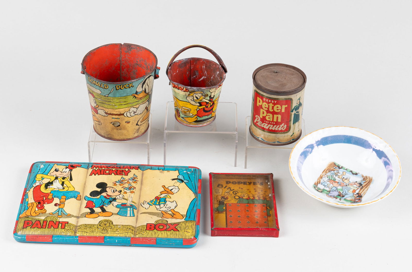 6 DISNEY TOYS: Six Disney toys. 'Magician Mickey Paint Box', two Donald Duck lunch pales, 'Peter Pan Salted Peanuts' can, 'Popeye's Bingo', and a Disney cereal bowl.