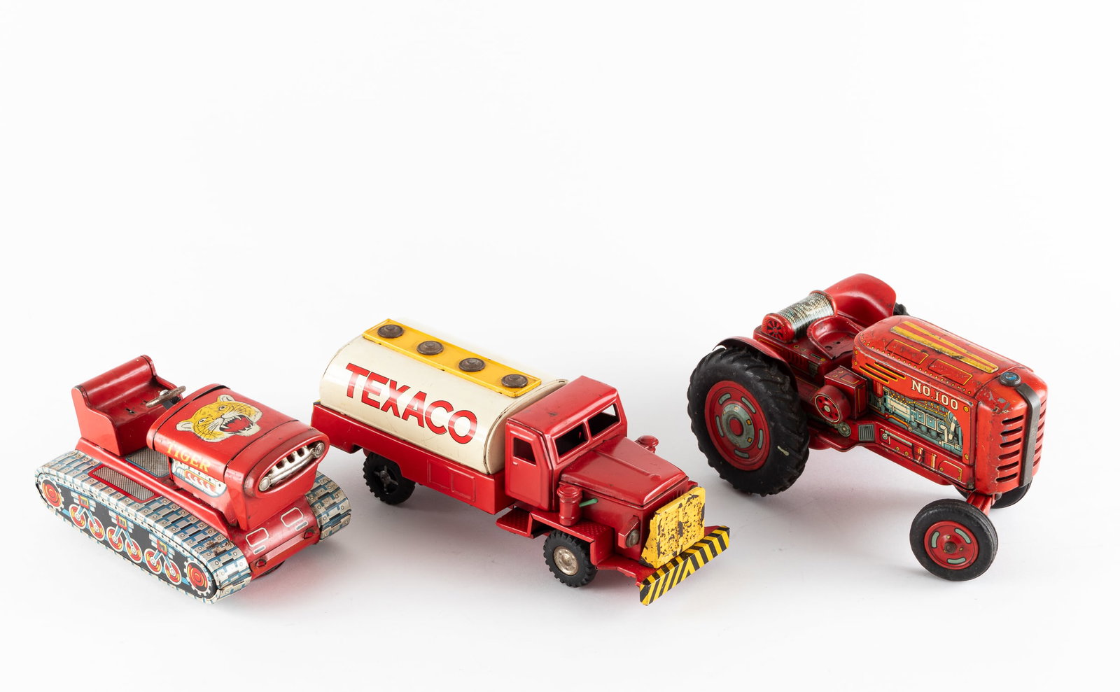 3 TIN TOY CARS: Three tin toy cars. Friction Texaco tank truck, friction functional, 9 inches long, made in Japan. 'Modern Toys' friction 'No. 100' tractor, partially functional, missing steering wheel, 8 inches long
