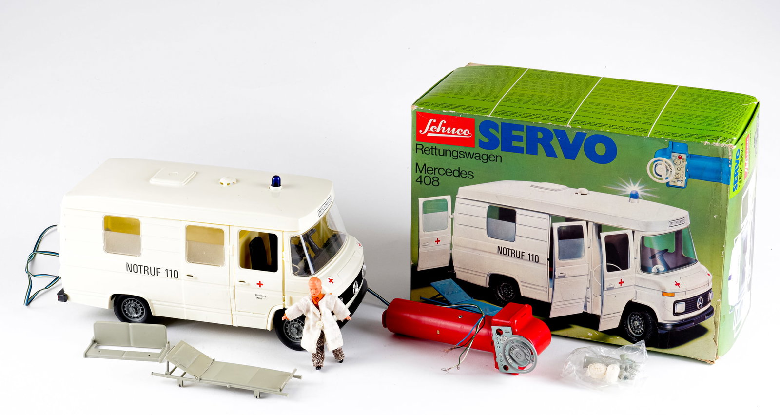 SCHUCO AMBULANCE: Schuco Ambulance Mercedes 408 Servo RC 362260, made in West Germany. With the original box. The remote cables have been cut from the remote, instructions and accessories are included, 12 inches long.