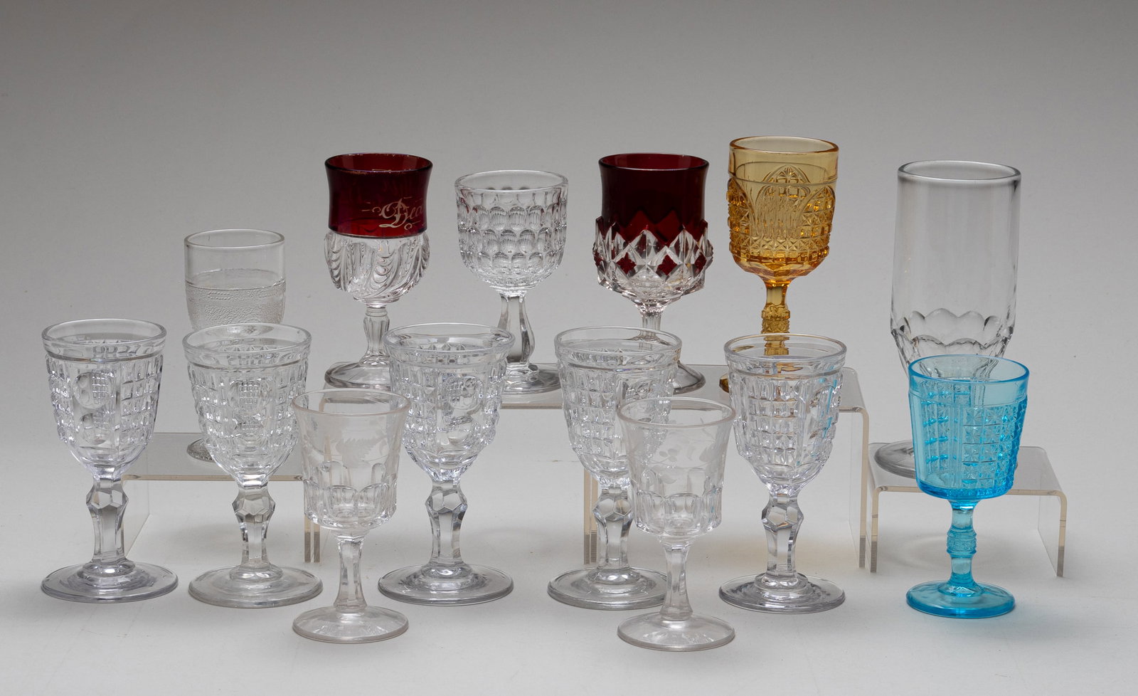 14 EAPG WINE AND ALE GLASSES: Lot of fourteen early American pattern glass ale and wine glasses. All height measurements. All clear pattern glass unless stated otherwise. Featuring: 1. Giant Baby Thumbprint wine glass. 3.75 inches