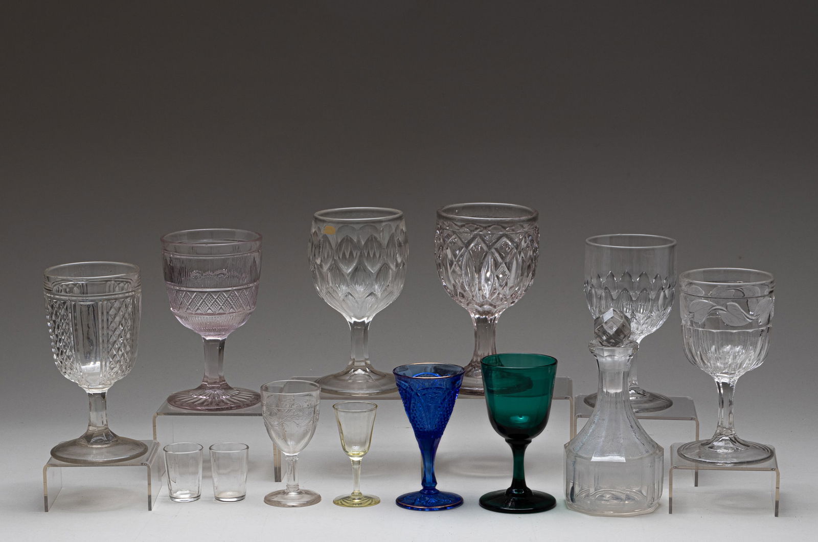 13 EAPG GOBLETS AND CUPS: Lot of thirteen early American pattern glass goblets and cups. All clear pattern glass unless stated otherwise. Featuring: 1. Hamilton goblet. 5.75 inches. 2. Almond and Thumbprint goblets. 5.75 inche