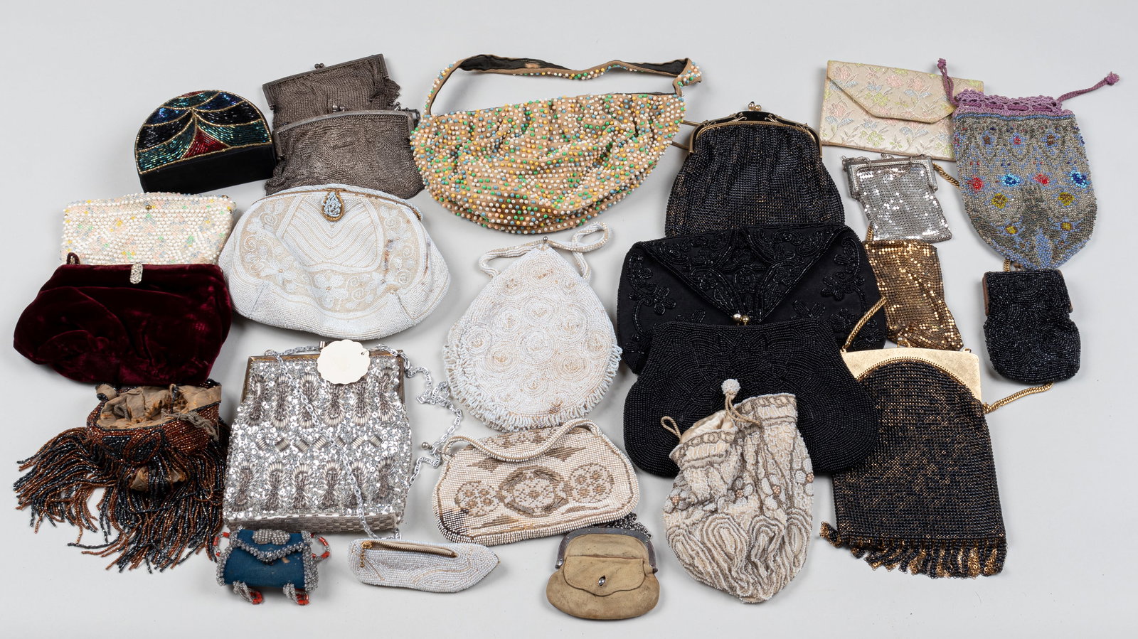 24 BEADED AND FABRIC PURSES: Twenty-four beaded and fabric purses, one leather purse.