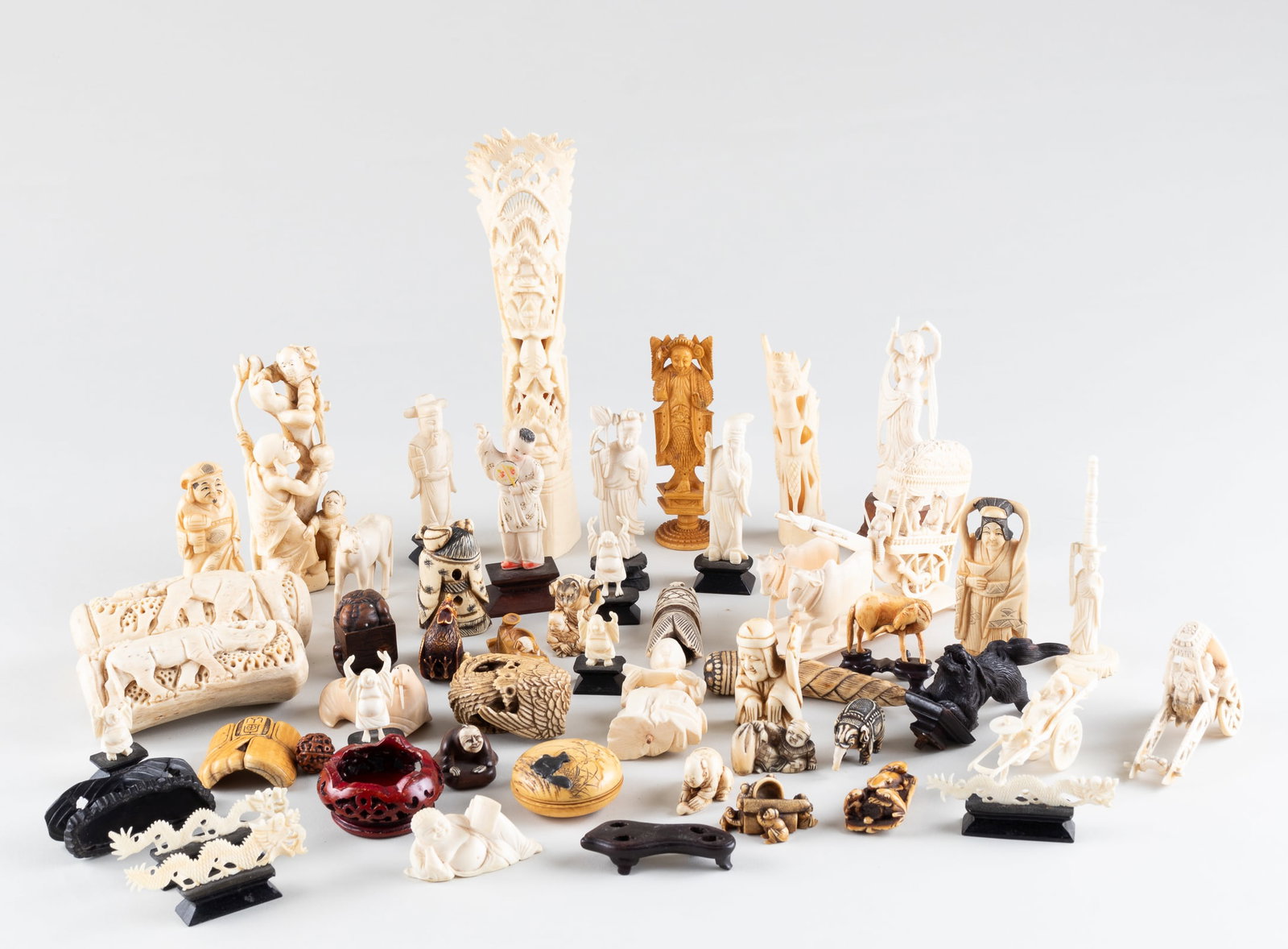 48 ANTIQUE IVORY, BONE, AND WALRUS IVORY CARVINGS: Forty-eight antique ivory, bone, and walrus ivory carvings. Featuring dragons, people, and an assortment of animals.Note: Lot 336 Three Antique Ivory Statues is blocked by Liveauctioneers. You can vie