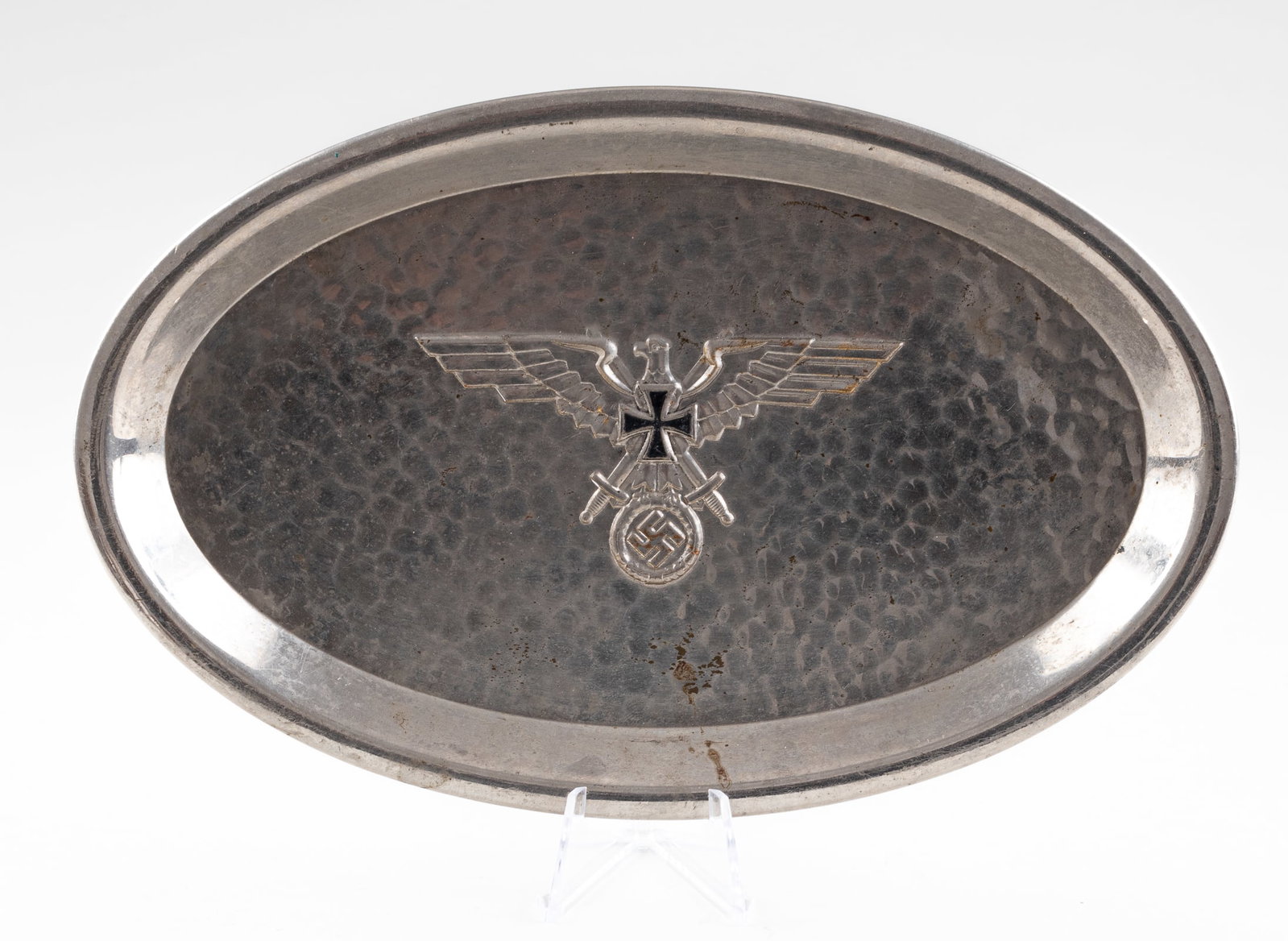 GERMAN WWII PRESENTATION TRAY: German WWII presentation tray with flared rim, featuring a Reichseagle clutching an oak leaf wreath mobile swastika in the center and an Iron Cross on the chest of the eagle. 9 x 5.75 inches.