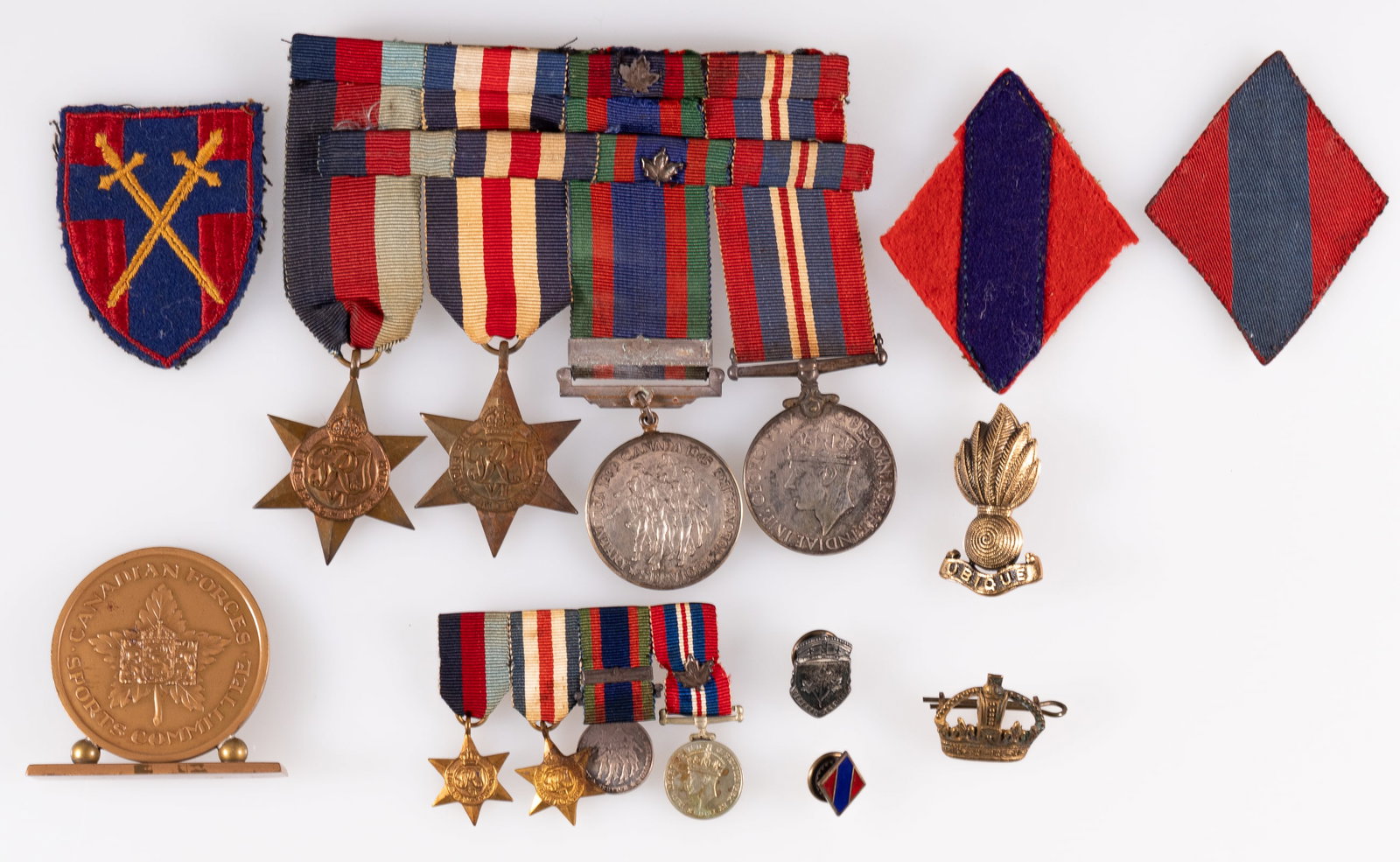 NAMED BRITISH CANADIAN WWII MEDALS: Lot of 16 named British-Canadian WWII medals and patches including a medal bar consisting of The 1939-1945 Star, The France and Germany Star, Canadian Volunteer Service Medal, and the War Medal 1939-1