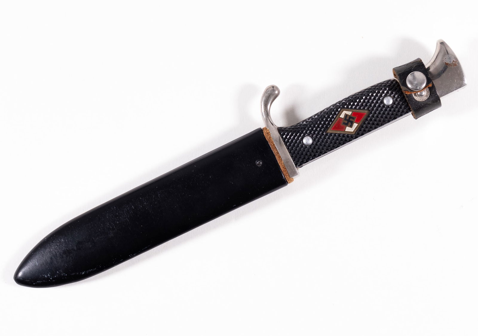 POST-WAR HITLER YOUTH DAGGER: Post-war Hitler Youth dagger with scabbard featuring an inlaid Hitler Youth symbol on the handle. Marked on one side of the blade '1940 - Blut und Ehre!' on the reverse reads 'MADE IN GERMANY.' Includ