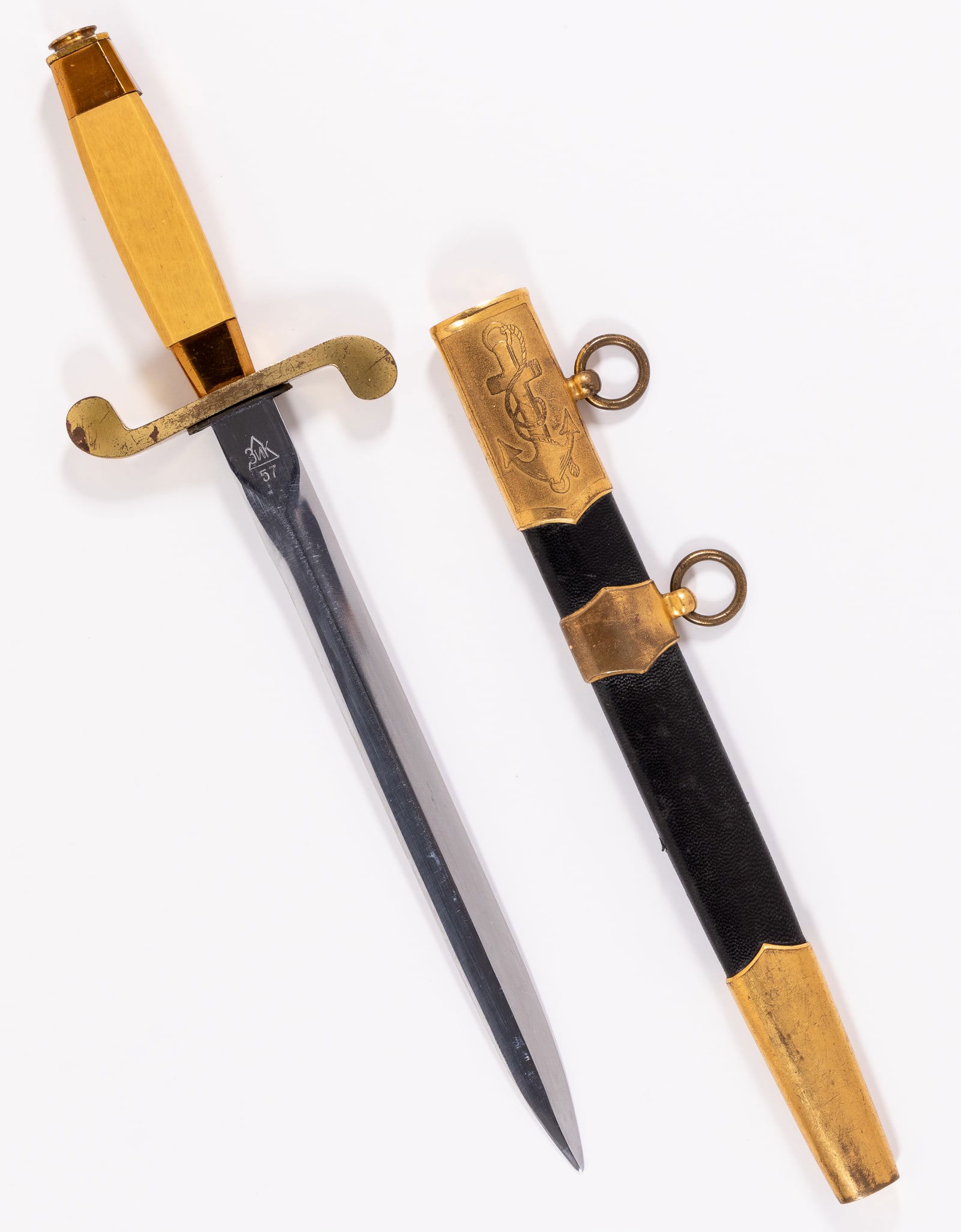 SOVIET NAVAL OFFICER'S DRESS DAGGER BY ZIK: Original 1957 Soviet Navy dagger made by Zik, clean blade, marked on the ricasso with serial number N33114 and 'Zik 57,' with leather scabbard and push button lock, brass locket and chape, brass band
