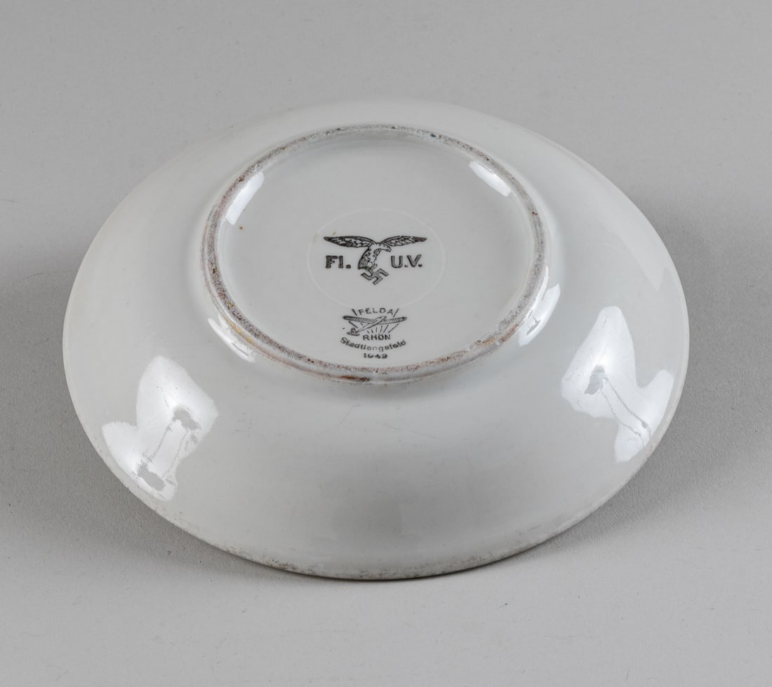 LUFTWAFFE FLIEGER CANTEEN PORCELAIN PLATE: WWII German Luftwaffe Fl. U.V. (Flieger Unterkunfts Verwaltung) porcelain plate marked on the bottom FL. U. V. with the Luftwaffe eagle and maker Felda Rhoen Stadtlengsfeld with the image of a glider 