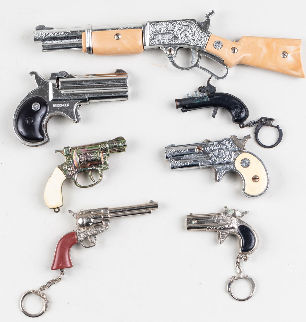 7 SMALL TOY CAP GUNS: Lot of seven small toy cap guns, some included are the Spitfire Hip Loading cap gun, Nichols Derringer cap gun, Nichols Dyna-Mite derringer cap gun, F.V.M. Police pistol multicolored chrome cao gun, a