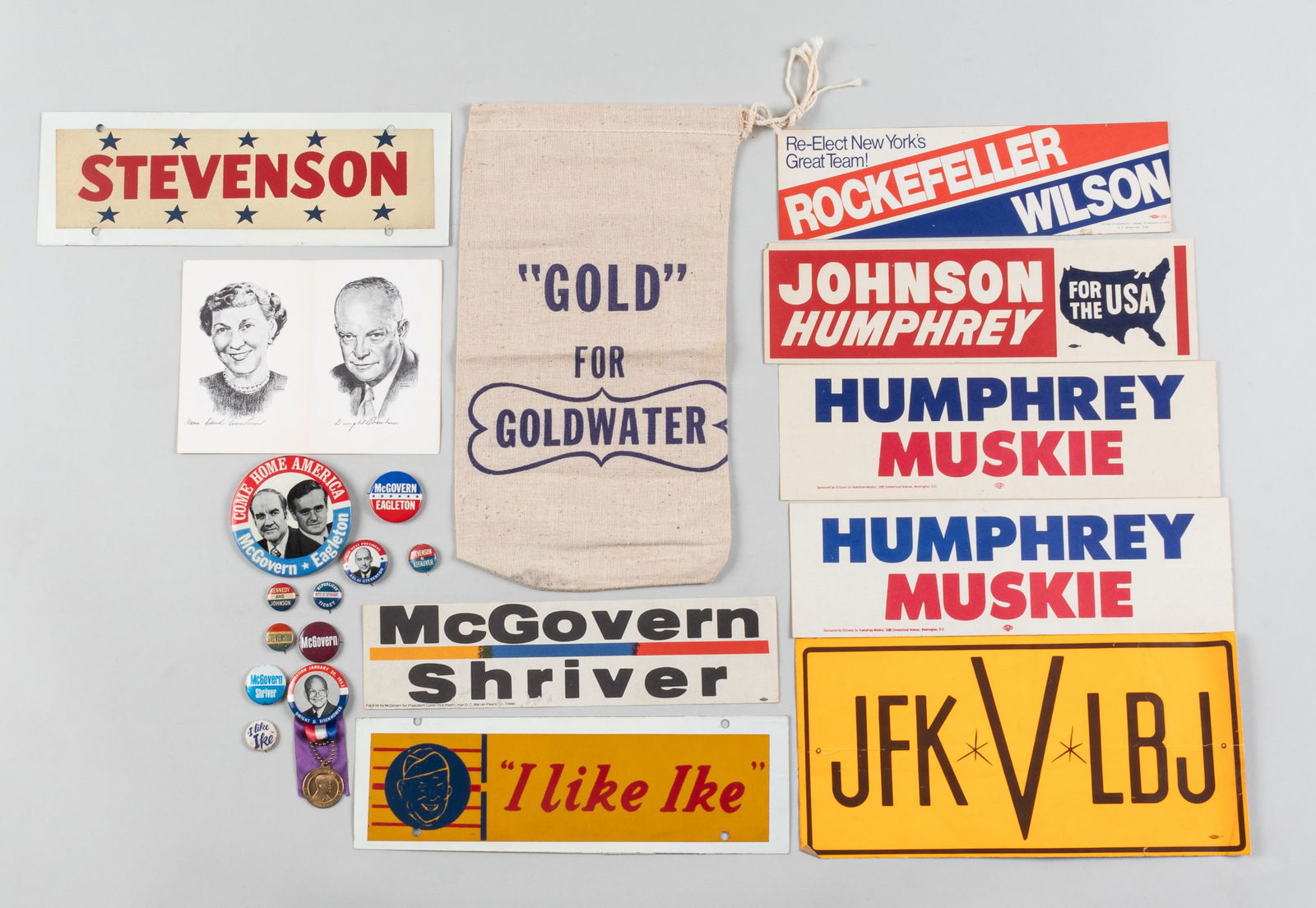 1950s AND 1960s CAMPAIGN MEMORIBILIA: 2 Eisenhower buttons, featuring an inauguration button from 1953 and 'I like Ike' button, one 'I like Ike' bumper sticker affixed to a white metal plate; 4 McGovern campaign buttons with one bumper st