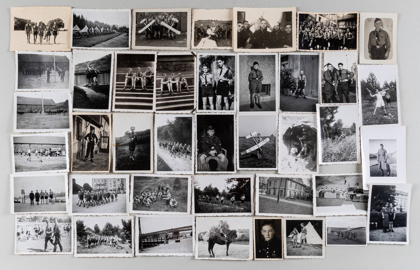 40 HITLER YOUTH PHOTOS: Lot of forty Hitler Youth b/w photographs including group photos, youth portraits, youth marching, youth around an airplane, and a youth flag raising. Between 1.75 x 2.5 inches and 2.75 x 3.75 inches 