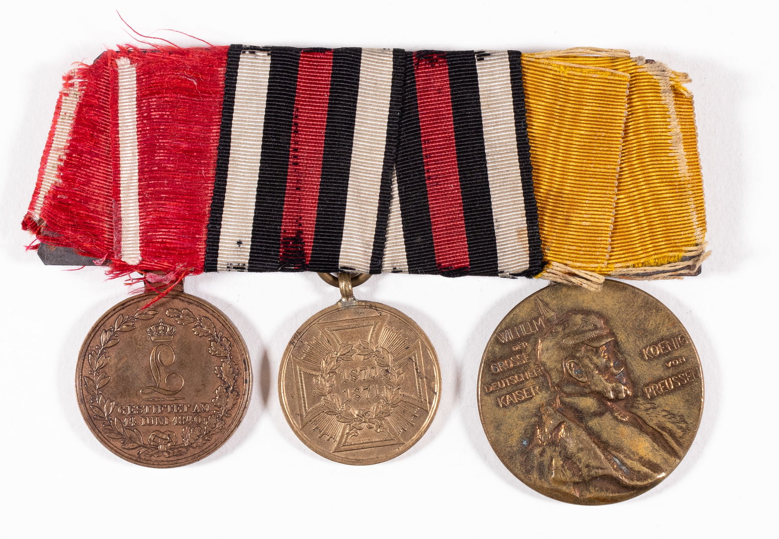 WWI IMPERIAL GERMAN MEDAL BAR: WWI Imperial German medal bar with three medals attached including the Field Honor Decoration medal, the War Commemorative 1870-1871 medal, and the Kaiser Wilhelm I Memorial medal.