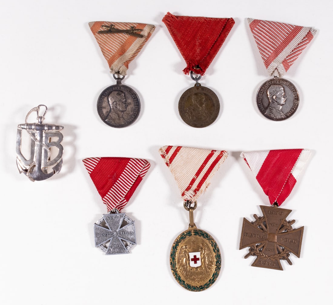 6 AUSTRIAN-HUNGARY MEDALS & UBOAT BADGE: Lot of six Austrian medals including two Silver Medals of Bravery, one ribbon with crossed swords, an Austrian-Hungary Red Cross Medal, a Cross of Honor 1939-1945, a Karl Troop Cross, and the Budapest