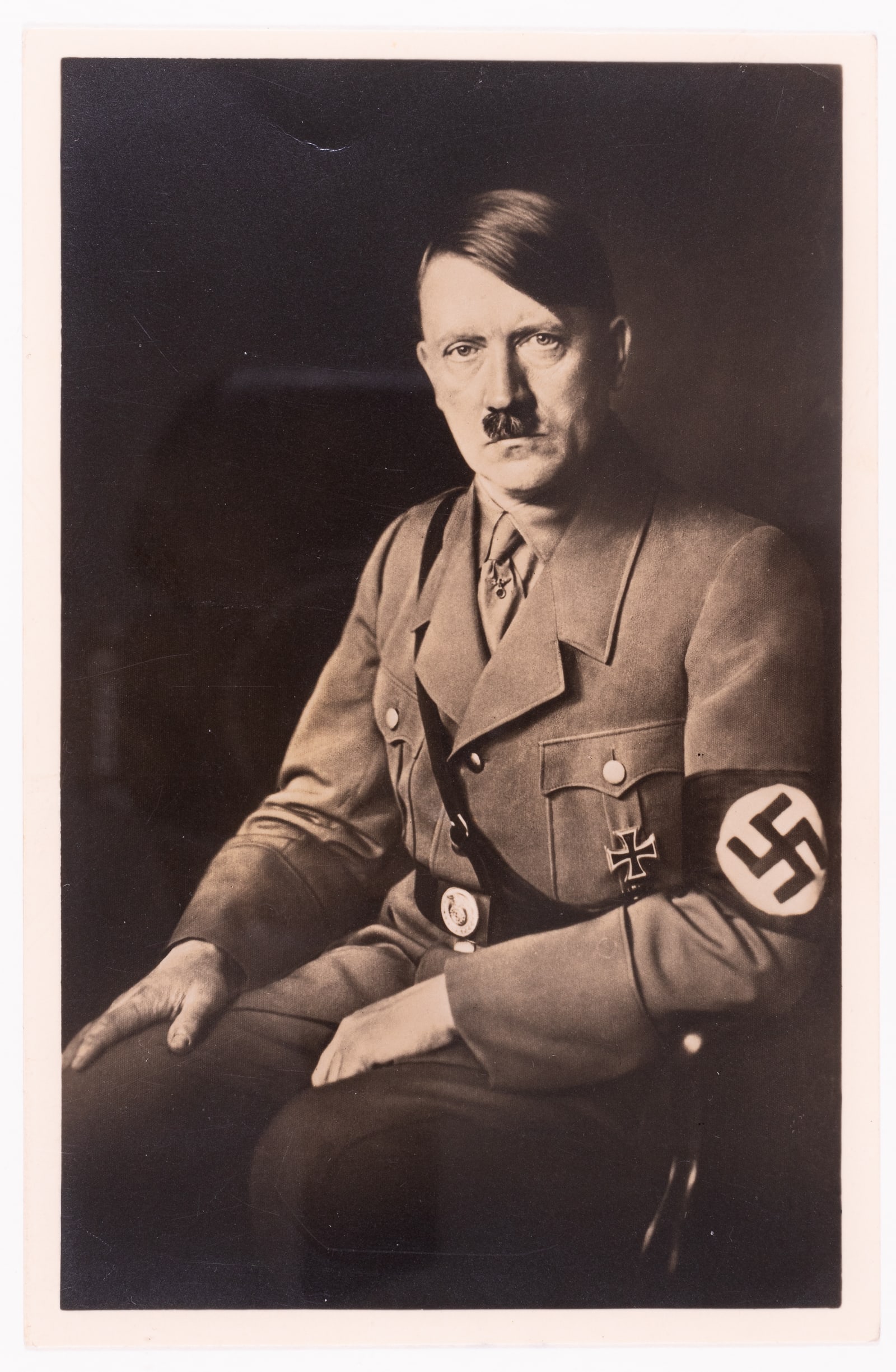 ADOLF HITLER PHOTO POSTCARD: Portrait photo postcard of Adolf Hitler, postage used, on the reverse reads 'Photo - Hoffmann, Munchen, Fredrichstr, 34.' With two cancelation stamps dated 1944 on the reverse. 3.5 x 5.5 inches.