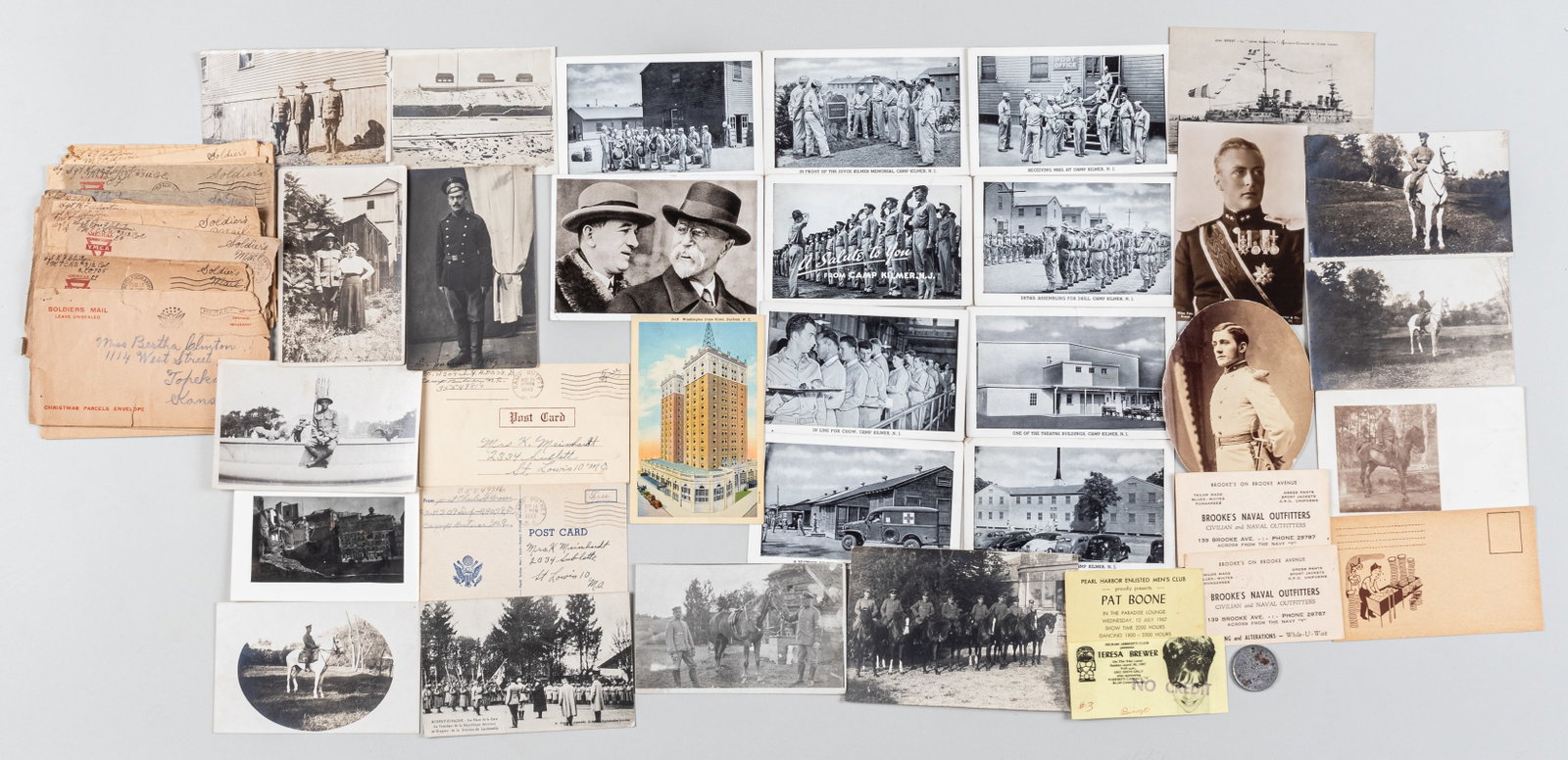 BIG LOT OF US WWI & WWII POSTCARDS, LETTERS, AND MORE: 49 pieces of WWI and WWII ephemera including 16 YMCA letter covers, postcards, and photographs. With a WWI Victory Liberty Loan medal with a hole punched in the top.