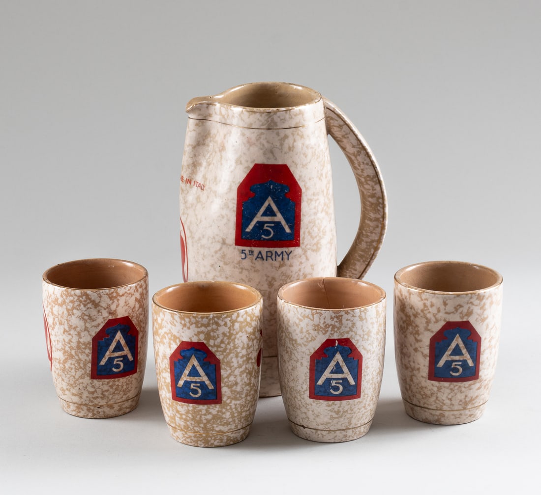 3133RD SONIC DECEPTION CO WINE SET: WWII American five-piece wine set for the 3133rd Sonic Deception Company to commemorate their time in Italy includes a wine pitcher and four cups. On each is painted the 5th Army insignia, 3133rd Thum