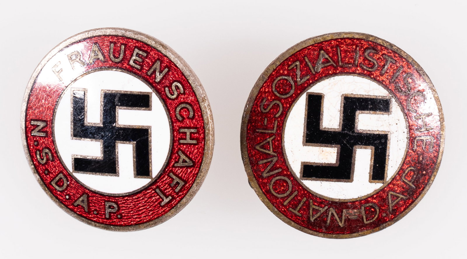 WWII NSDAP MEMBERSHIP BADGES (2): Lot of two WWII German NSDAP membership badges, one marked on the reverse 'Osang-Dresden - Ges Gesch,' and the other marked on the reverse 'M1/25' for Rudolf Reiling in Pforzheim, with the RZM stamp a