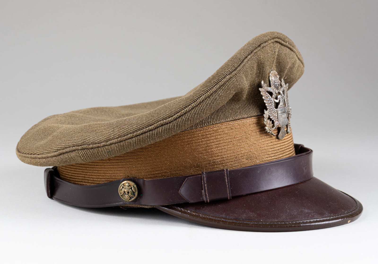 WWII USAAF OFFICERS VISOR CAP HAT: WWII US Army Air Force officers visor cap with a nice peak, made by The Henderson-Ames Co, Kalamazoo, Michigan. With insignia, chinstrap, intact sweat shield, beaded edge visor shield in good conditio