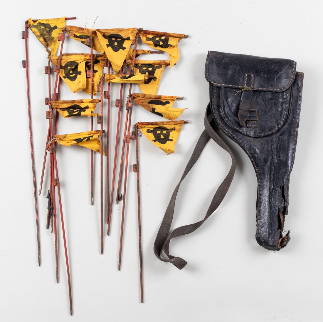 13 WWII GERMAN MINE STAKES W/ HOLSTER: WWII German Wehrmacht mine staking kit, includes thirteen mine stakes with yellow flags and black skulls on them, also includes the black leather carrying holster, with the Wehrmacht equipment stamp a