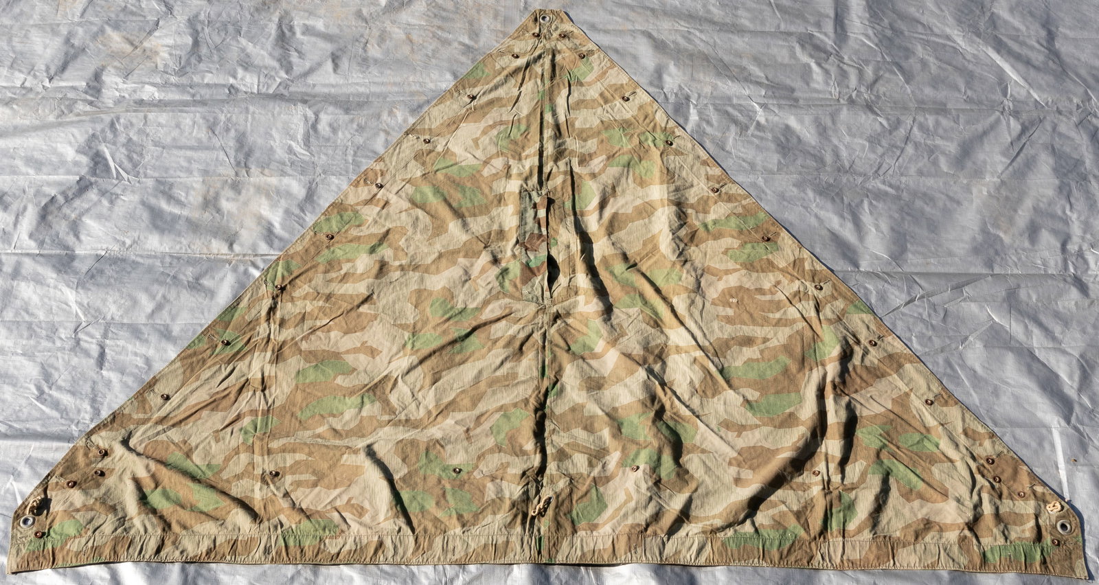 WWII GERMAN CAMO ZELTBAHN M31 TENT QUARTER / PONCHO: WWII German M31 Zeltbahn triangular-shaped tent quarter / poncho with splinter pattern camouflage. 90 inches long and 66 inches wide. Metal buttons, some replaced, reinforced buttonholes, metal gromme