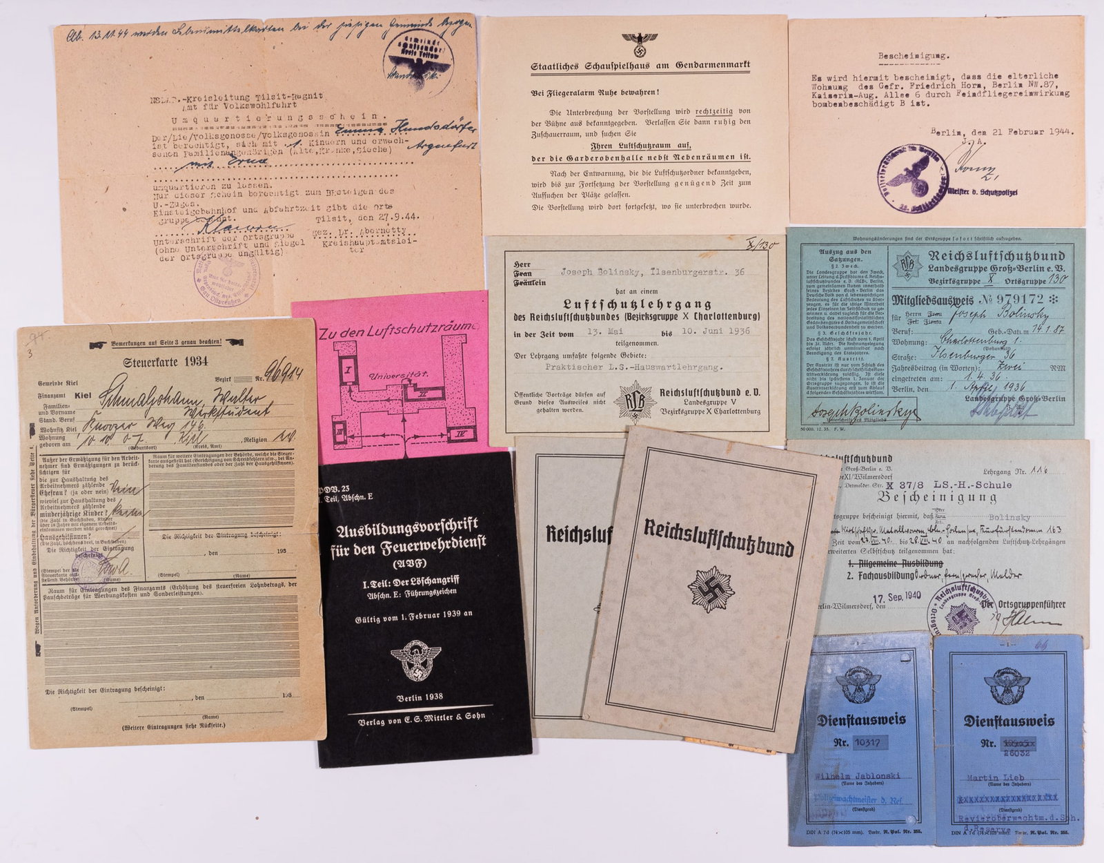 WWII GERMAN LUFTSCHUTZ EPHEMERA (11): Lot of eleven pieces of WWII German Luftschutz Bund and other ephemera, including a Luftschutz Bund membership book, three Luftschutz ID cards, one with fingerprints on the back, an auditorium air rai