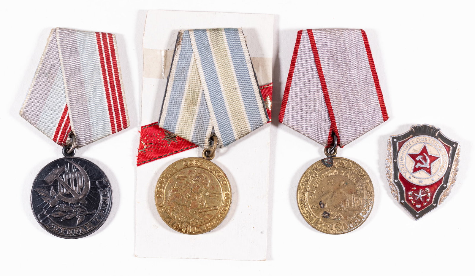 13 SOVIET MEDALS AND AWARDS: Lot of 4 Soviet medals and 9 award certificates; medals include the Excellent Soldier of the Soviet Army badge, Defense of the Polar Region medal, Veteran of Labor medal, and the Defense of Caucasus R