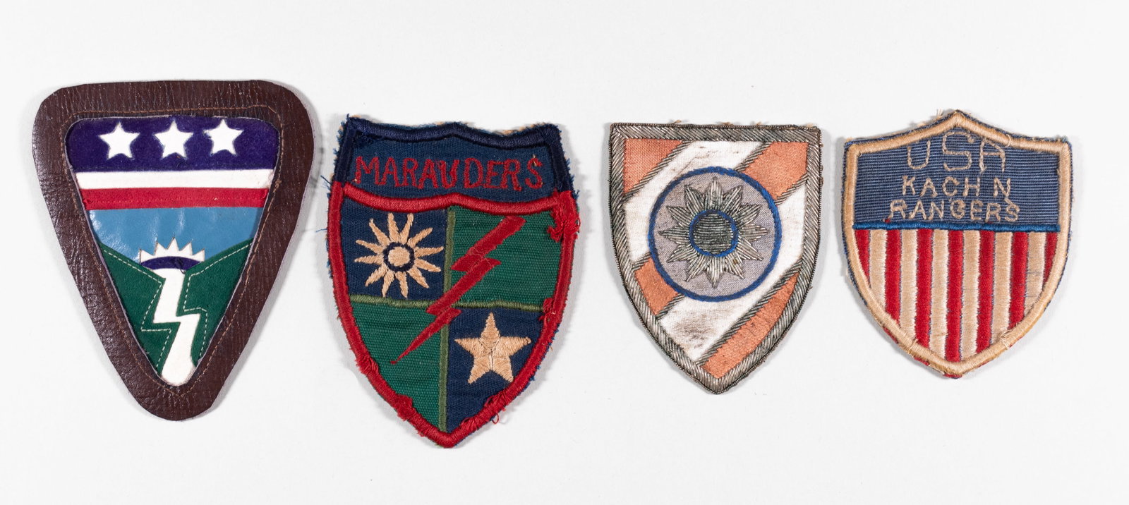 4 WWII US CBI PATCHES: Lot of four WWII US CBI patches, including the Ledo Road felt and leather patch, CBI Chinese Combat Training bullion patch, 5307th Merrill's Marauders patch, and the Kachin Rangers patch. Between 3 x 
