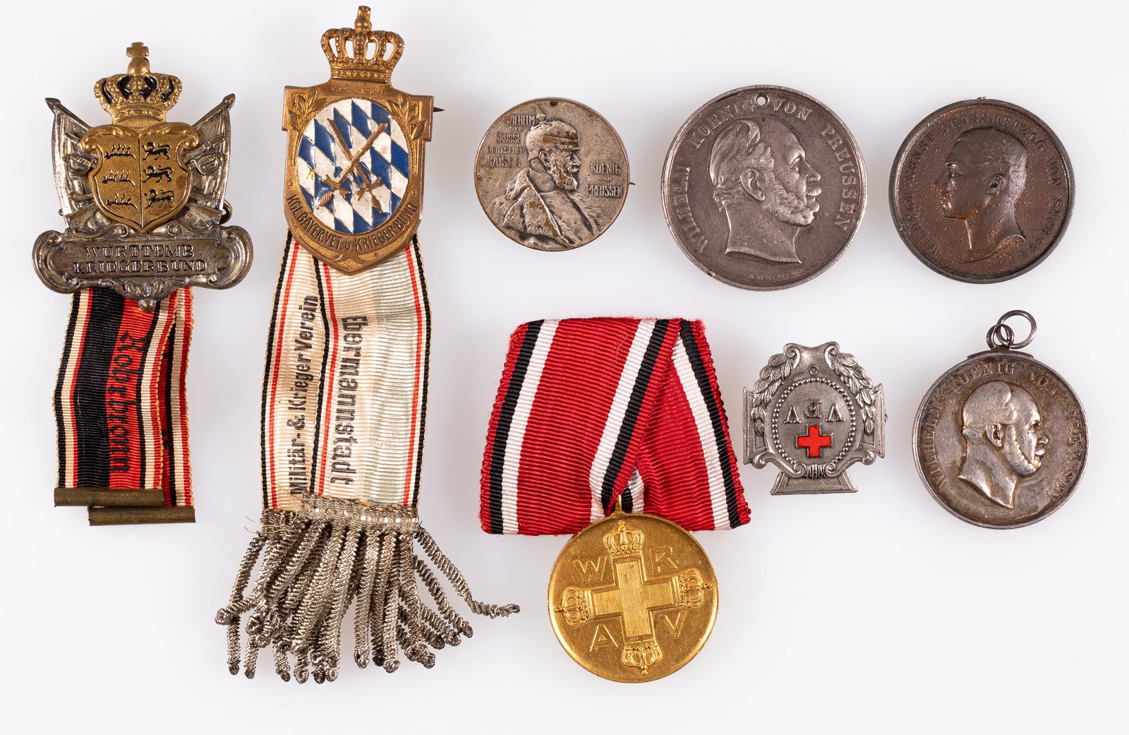 IMPERIAL GERMAN MEDALS AND BADGES (8): Lot of eight Imperial German medals and badges, including the Vaterl?ndischer Frauenverein badge, the Prussian Red Cross Medal 2nd class, the Wurttemburg Veterans badge with ribbon, the Bavarian Warri