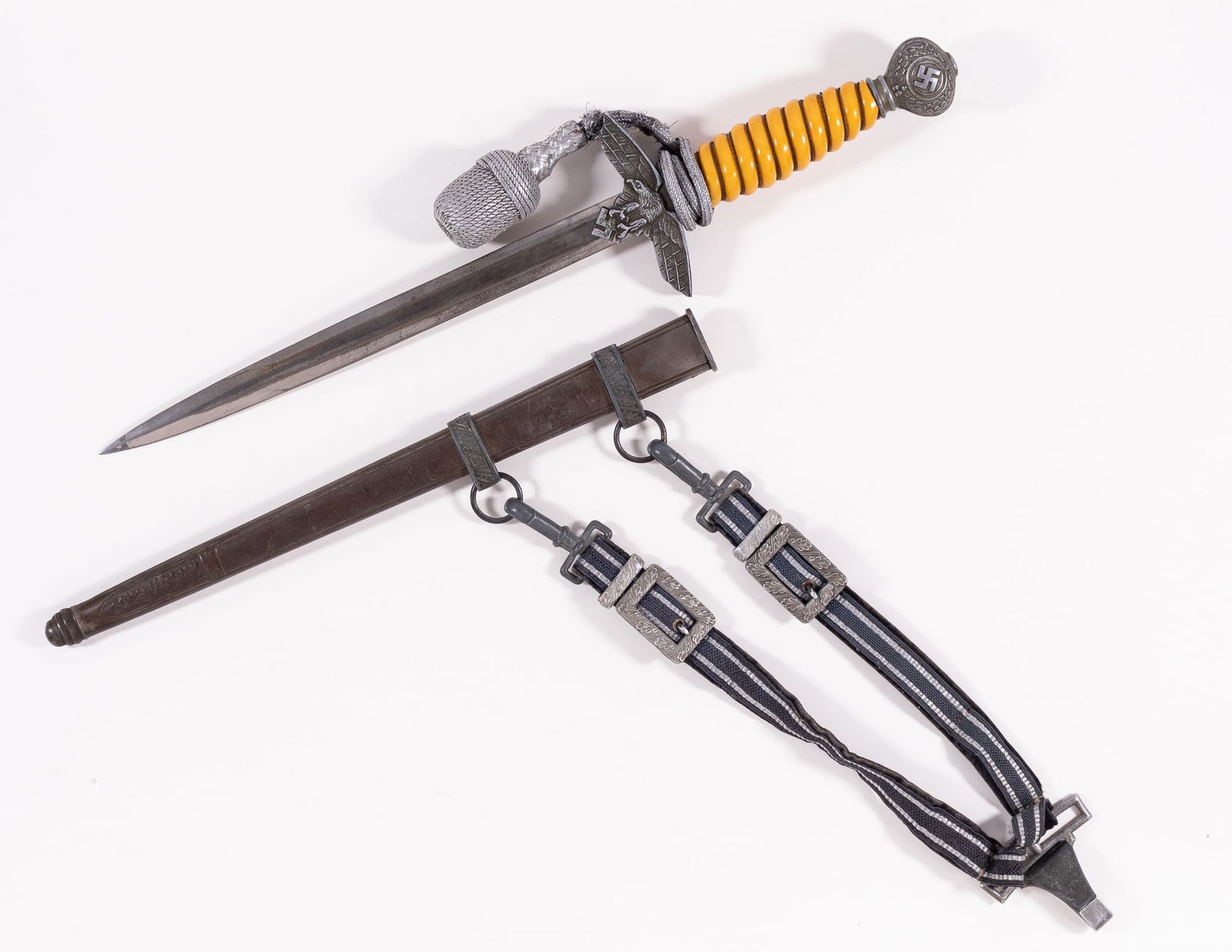 GERMAN WWII LUFTWAFFE DAGGER W/ HANGERS & PORTAPEE: German WWII Luftwaffe dagger second model, with scabbard, hangers, and portapee. The blade is unmarked and bears a felt pad, a fine point, some oxidation, and running marks. Orange grip has no visible