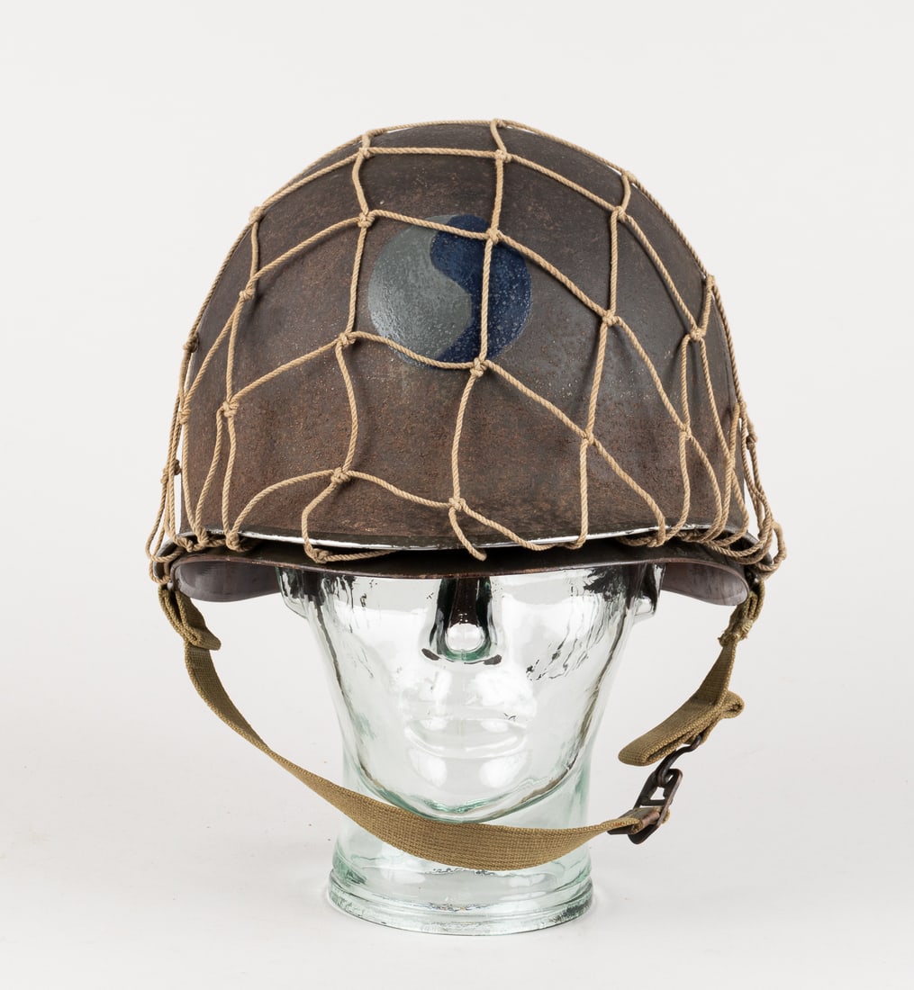 29TH INFANTRY DIVISION D-DAY M1 NAMED HELMET: WWII 29th Infantry Division D-Day M1 steel helmet, with fixed bales shell that is complete with chin straps, heat stamp number '306 A' marked along the front inside of the helmet, inside liner with na
