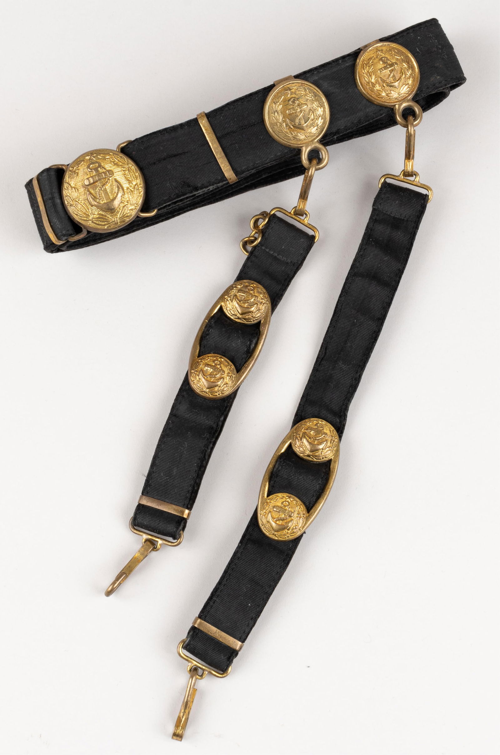 BULGARIAN M51 NAVY OFFICER DRESS BELT W/ HANGERS: Bulgarian M1951 Navy officer's dress belt with dagger hangers, brass buckle with brass fittings with a fouled anchor. 45 inches long.