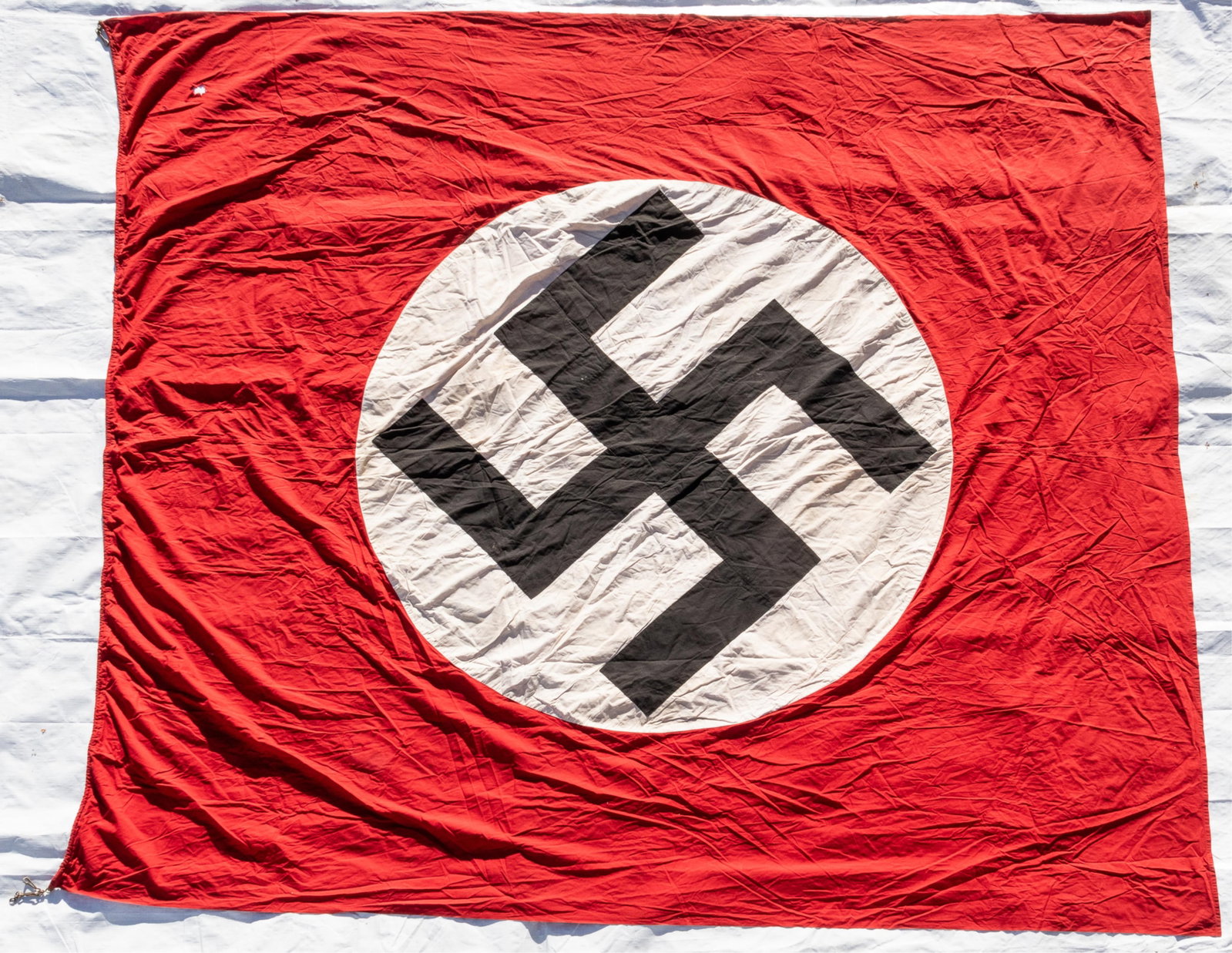 LARGE GERMAN WWII NSDAP FLAG: Large WWII German NSDAP swastika party double-sided flag, four-piece cotton construction, two-piece red background and two-piece white swastika with black background sewn together, rope sewn into hois