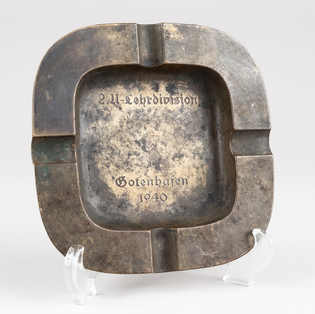 WWII GERMAN U-BOAT ASHTRAY: WWII German U-Boat brass ashtray, debossed in the center '2. U-Lehrdivision Gotenhafen 1940' [2nd Training Division Gotenhafen] with a mobile swastika and fouled anchor symbol. Approx. 8 x 8 inches. E