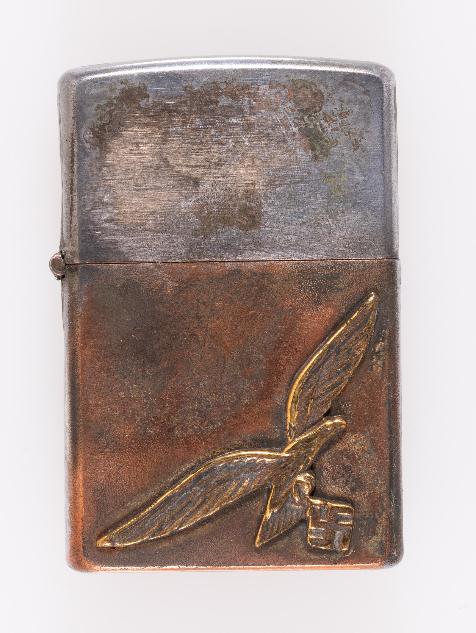 LUFTWAFFE ZIPPO STYLE CIGARETTE LIGHTER: Zippo-style cigarette lighter affixed with Luftwaffe eagle clutching a swastika insignia at the bottom right. Small RZM logo on the bottom of the lighter. Sold as is.