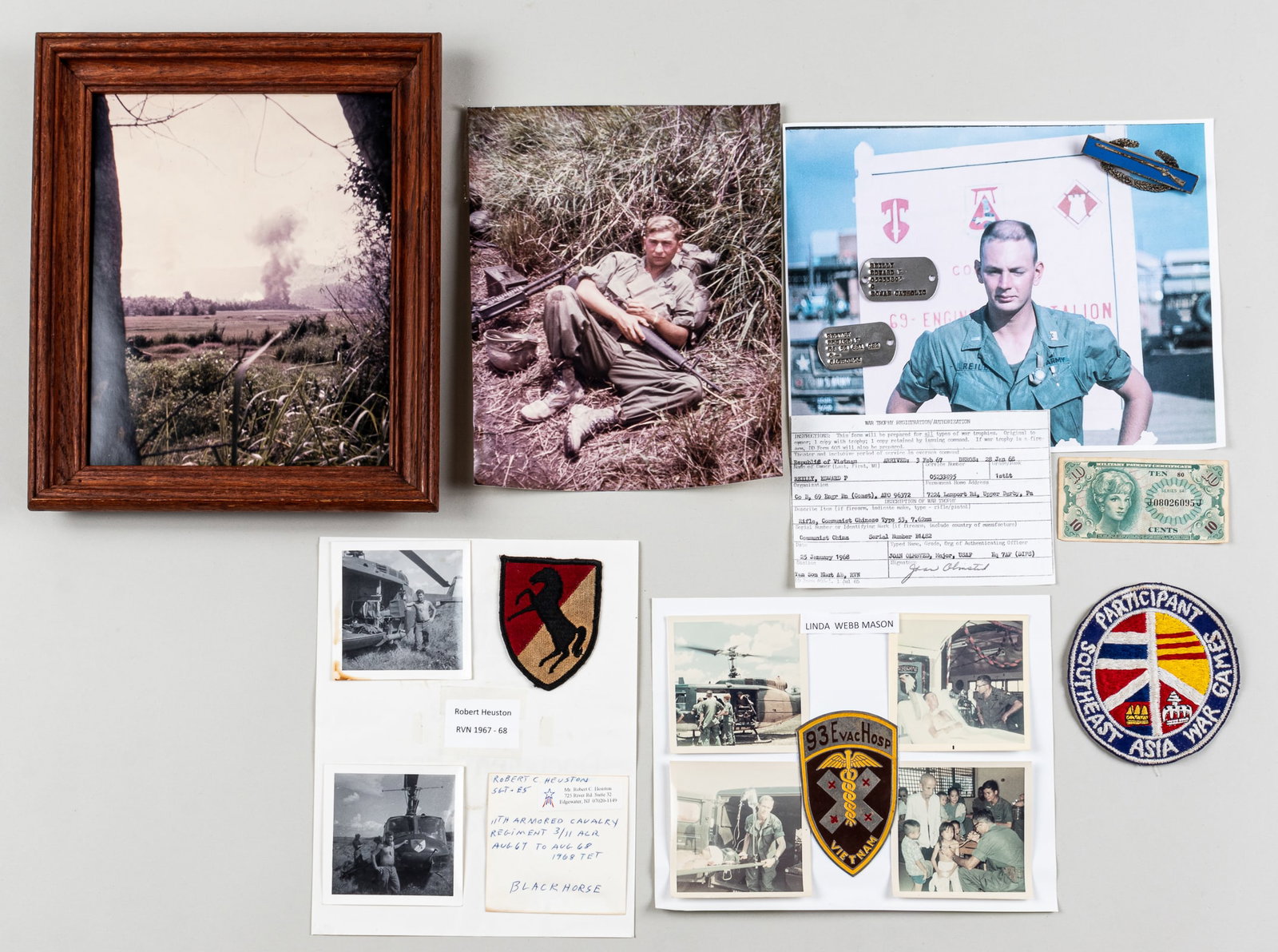 VIETNAM SOLDIERS GROUPING: Grouping of photos and personal belongings from four soldiers in the Vietnam War, including a photo, two dog tags, a Rifleman Infantry badge, a Southeast Asia War Games Participant patch, a War Trophy