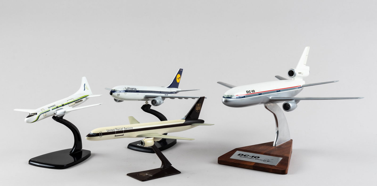 PASSENGER CARRIER MODEL PLANES (4): Lot of four model airplanes of passenger carrier craft, including a DC-10 Mcdonnell Douglas model plane, 13 x 12 x 4 inches, Summit N5345A small passenger plane model, 6.75 x 8.5 x 2 inches, a Lufthan