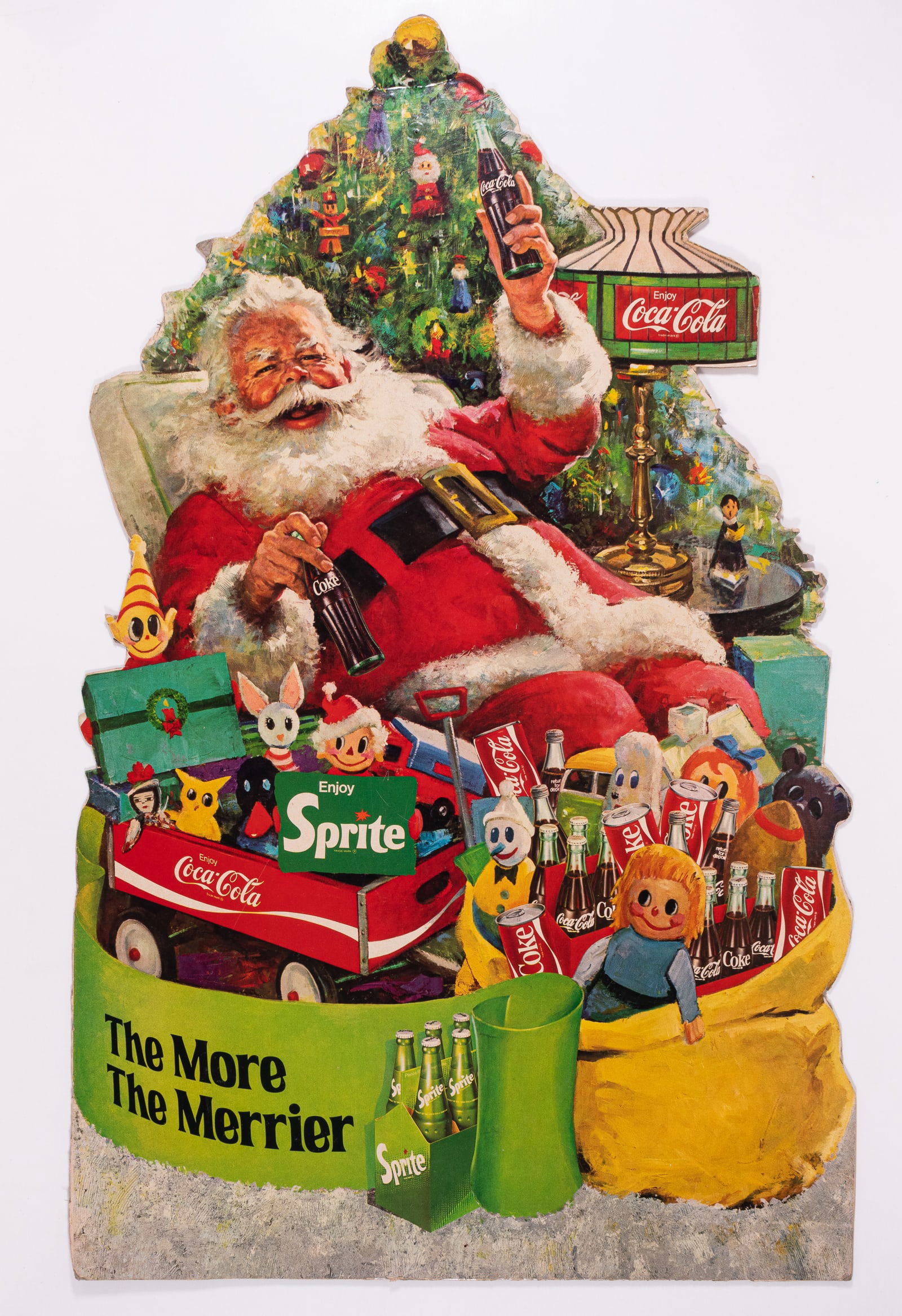 COCA-COLA CHRISTMAS SANTA ADVERTISEMENT: Coca-Cola Christmas advertisement features Santa Claus holding two Coca-Colas in each hand. The cardboard advertisement, titled 'The More the Merrier,' measures 15 x 23.5 inches and is very nice.