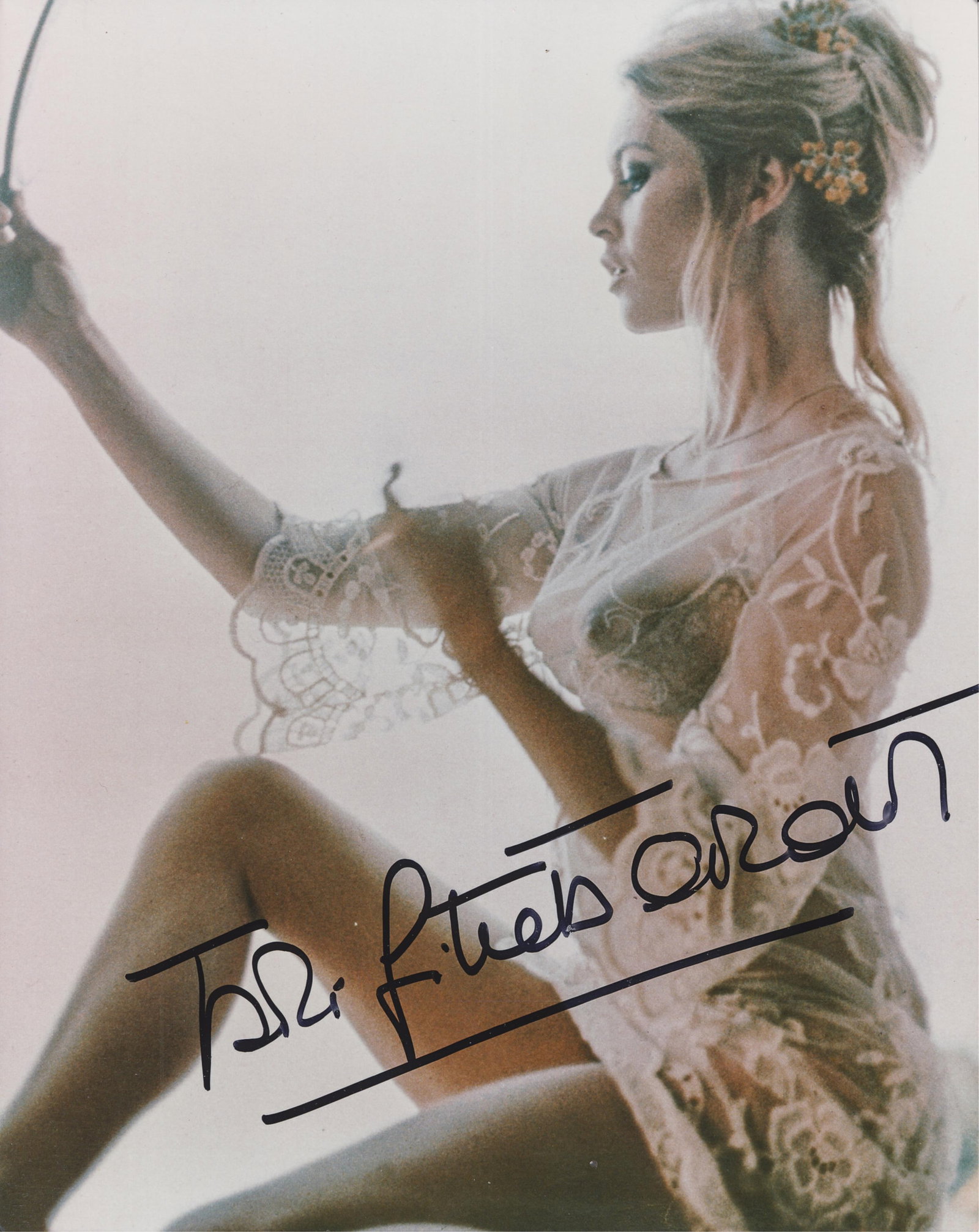 BRIGITTE BARDOT: (b. 1934) French actress, chanteuse, and animal rights activist. BB is among the greatest sex symbols of all time. A signed color photograph of Bardot dressed in a sheer lace babydoll, autographed in 