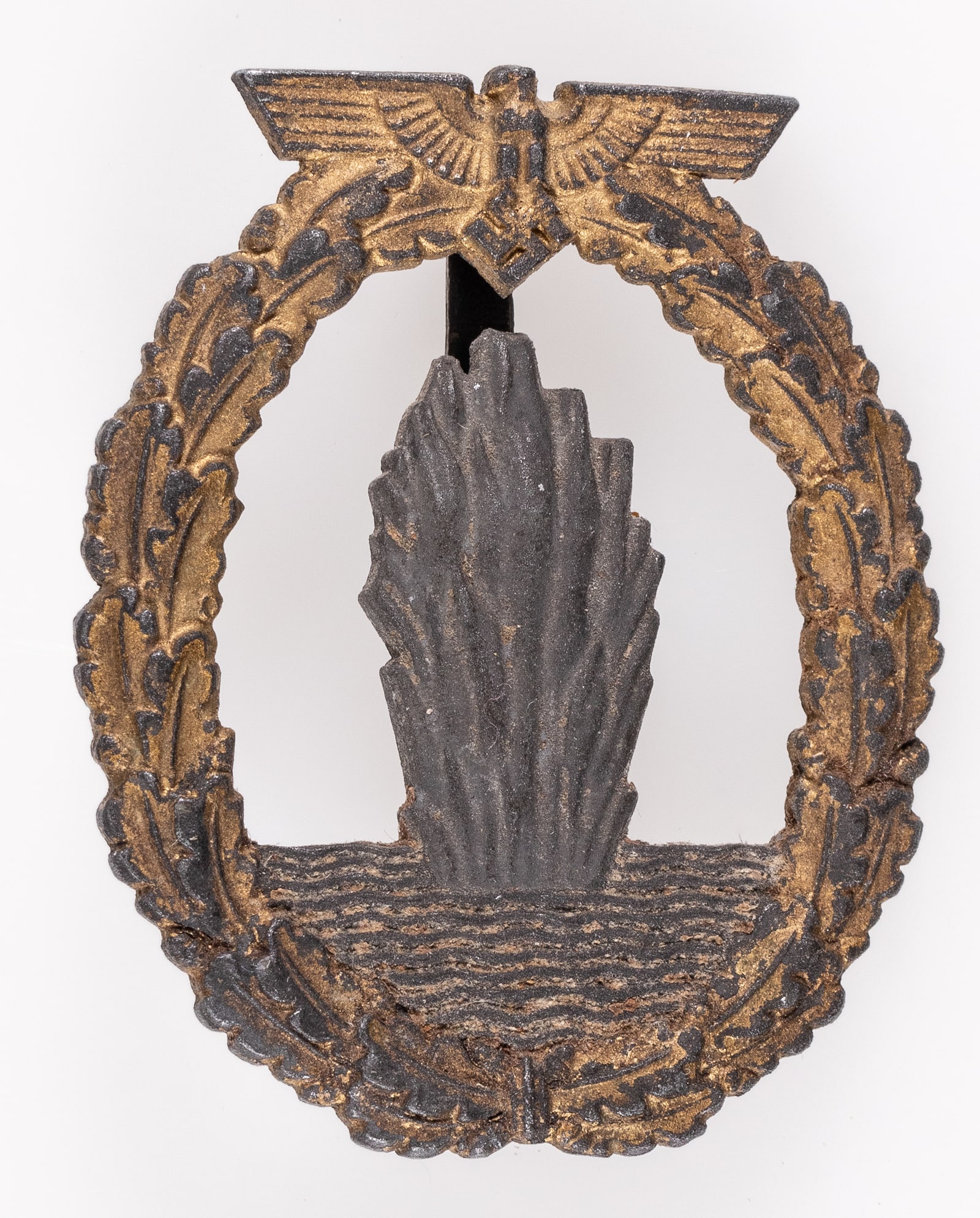 WWII GERMAN KRIEGSMARINE MINESWEEPER BADGE PAUL MEYBAUER: WWII German Kriegsmarine Minesweeper badge, unmarked, in design, and with c clasp pinback for maker Paul Meybauer of Berlin. Zinc construction with gold coloring to the wreath and waves, wear and loss