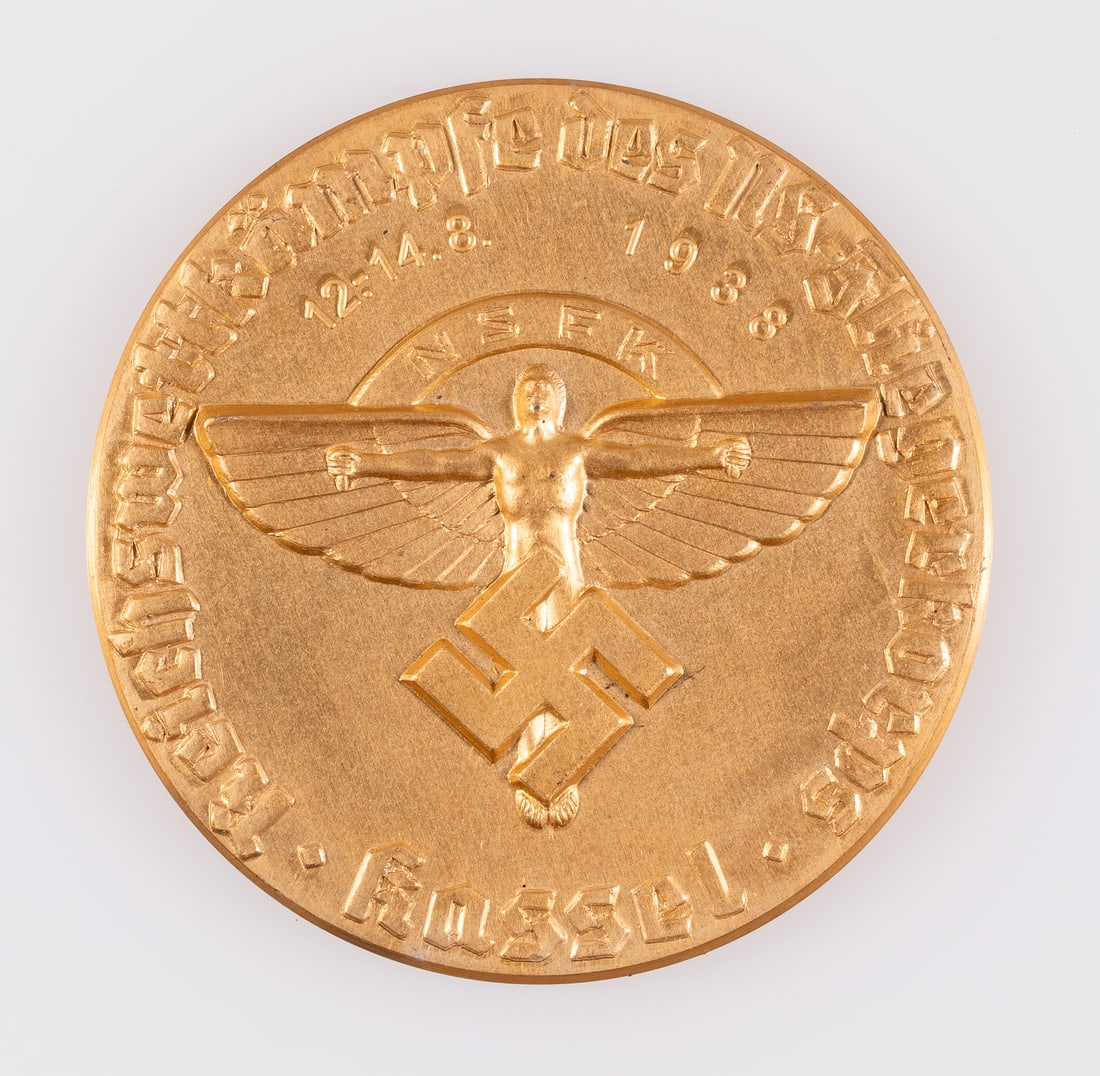 THIRD REICH NSFK FLIGHT DAY COMMEMORATIVE MEDAL: German Third Reich NSFK 1938 flight day commemorative table medal with original case, the front reads 'Reich competitions of the NS Air Corps - Kassel - 12-14.8.1938.' Gold-colored table medal, 3.25 i