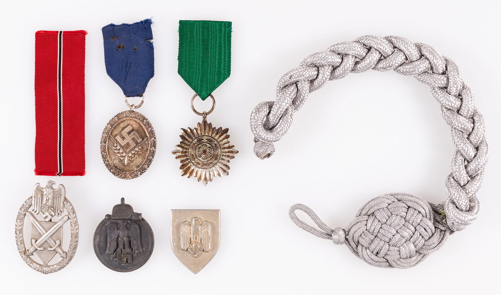 6 WWII GERMAN MEDALS AND BADGES: Lot of six WWII German medals and badges, including an Ostvolk medal, in silver with no swords, all green ribbon, an Eastern Front medal, an RAD Long Service medal in 3rd class, an Army shooting lanya