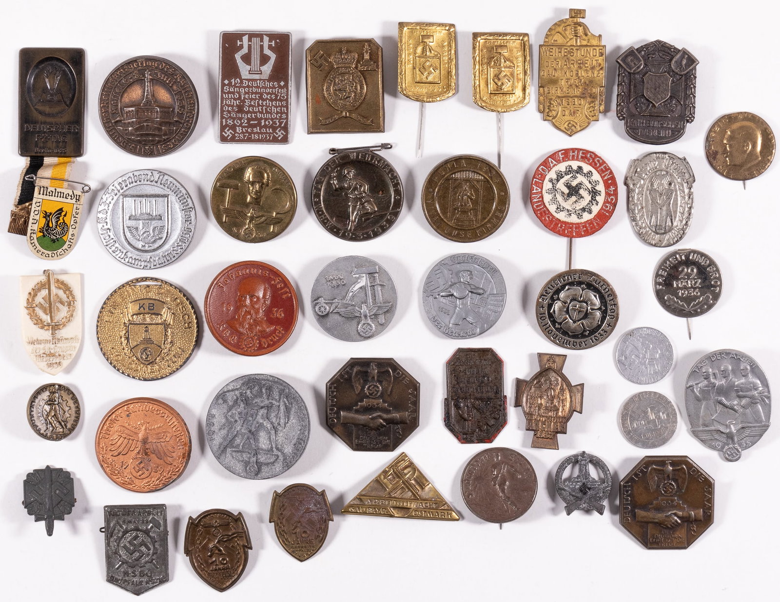 40 GERMAN THIRD REICH BADGES AND TINNIES: Lot of forty German Third Reich badges and tinnies, including an assorted mix, some with pinbacks, some missing their pinbacks. Sold as-is.
